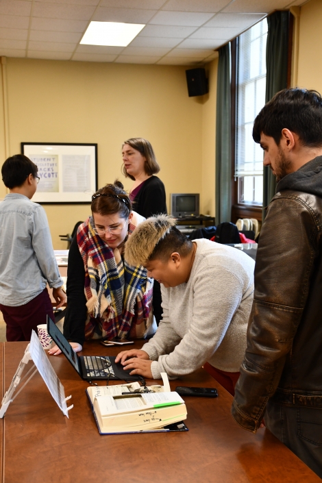 People looking at objects at the Bibliocircuitry: Old Books, New Stories showcase