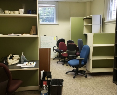 The lab space filled with cubicles, chairs, bookcases, and other furniture