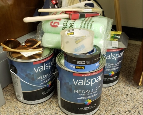 Cans of paint and painting supplies